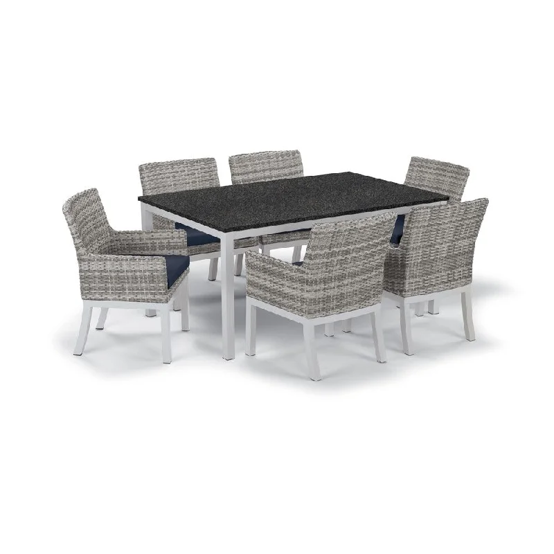 Oxford Garden Travira 7-Piece Dining Set with 63-in x 40-in Lite-Core Charcoal Table, Argento Wicker with Midnight Blue Cushion